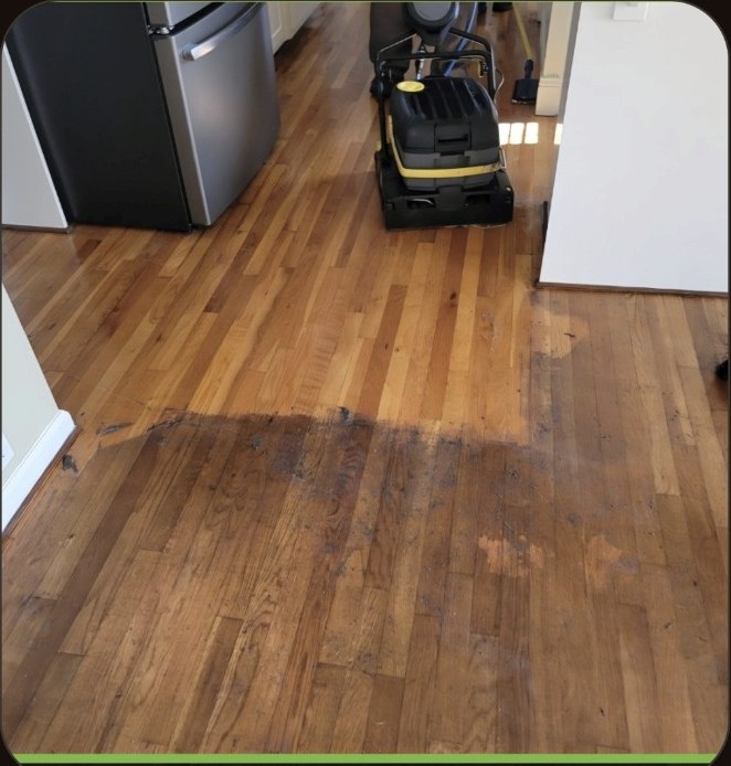 Wax and acrylic coating removal in progress on a hardwood floor