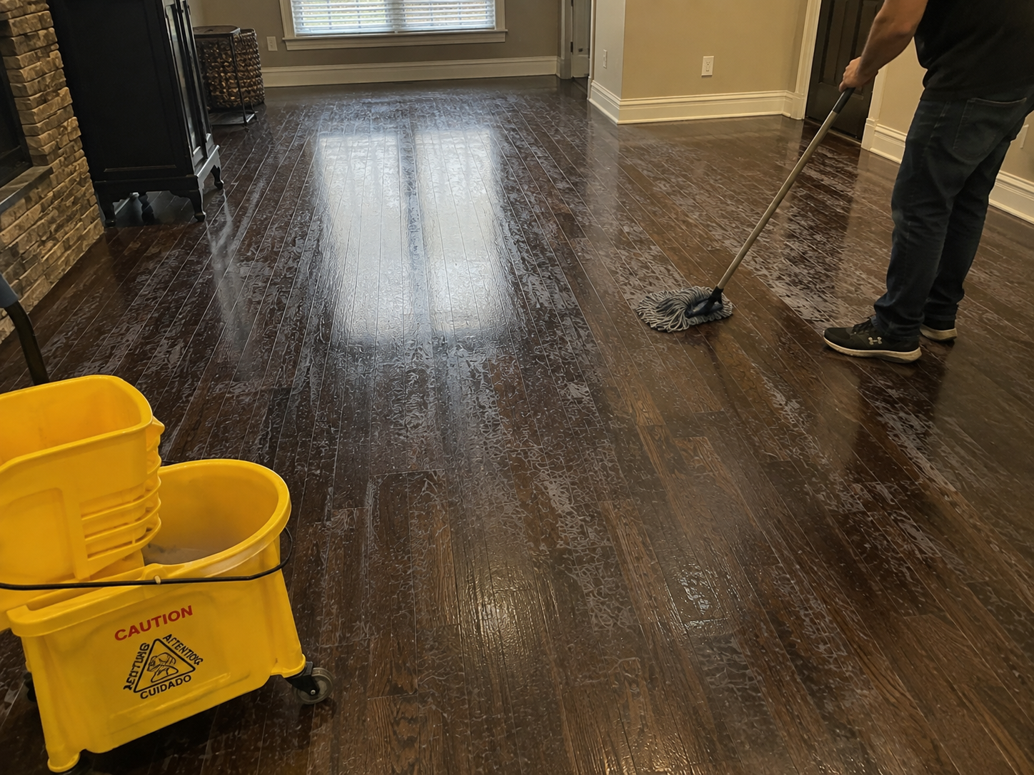 Wax removal in progress showing dark buildup and lighter revealed hardwood